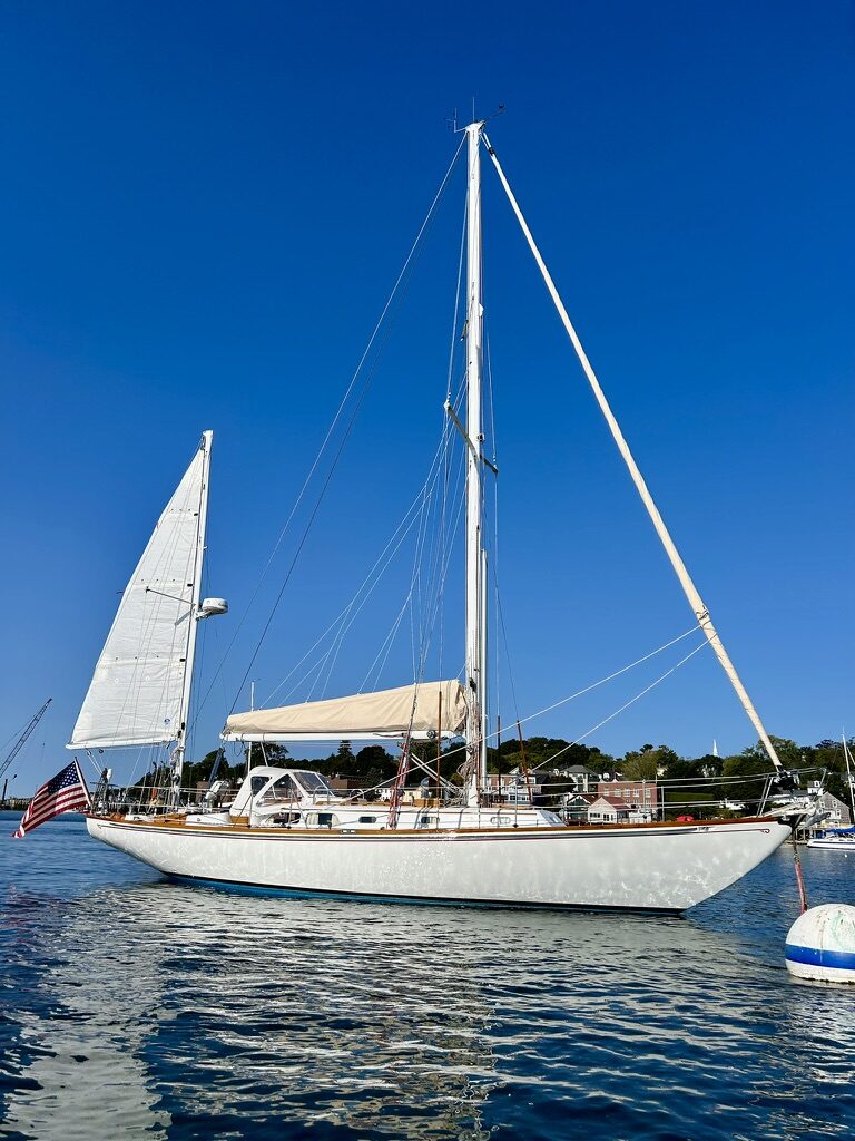 Malabar at anchor, awning rigged, flag flying